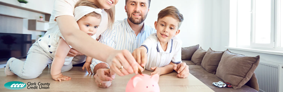 Family putting coins in piggy bank